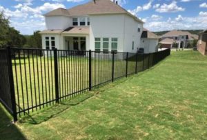 wrought iron fence in neighborhood creating perimeter